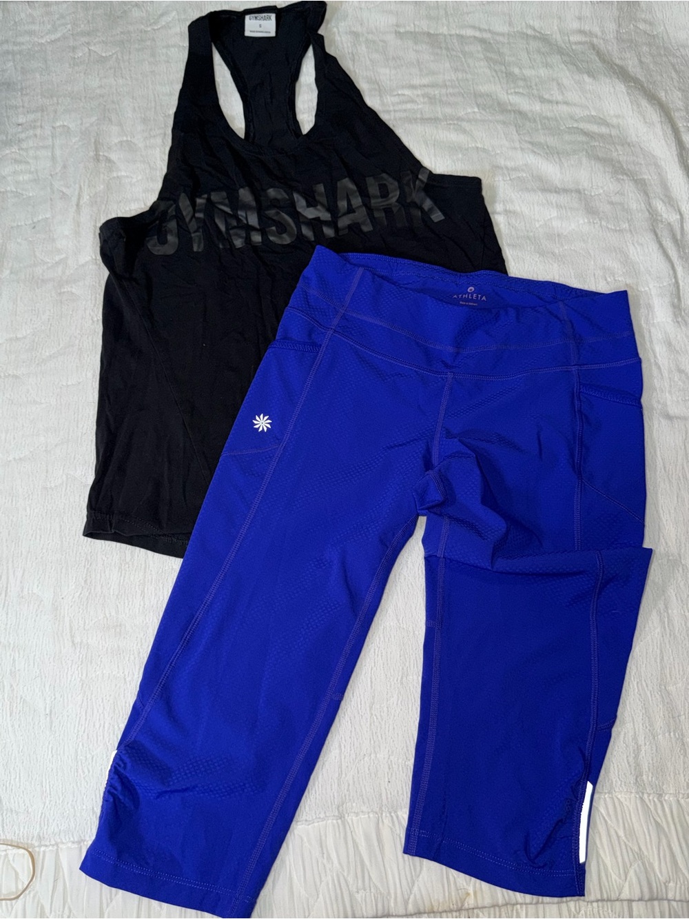 Athleta Royal Blue Capri Leggings for Women and Gymshark sleeveless sports shirt